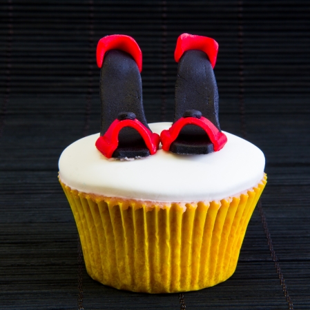 cup cake with black and red shoesの写真素材
