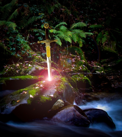 sword stuck in a river rockの写真素材