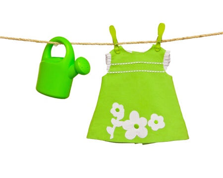clothesline with baby clothes and sprinklerの写真素材