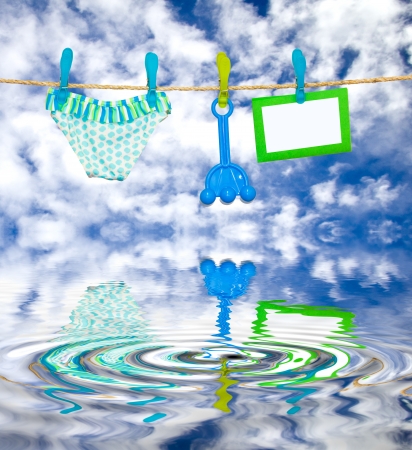 clothesline with reflected swimsuit and toysの写真素材