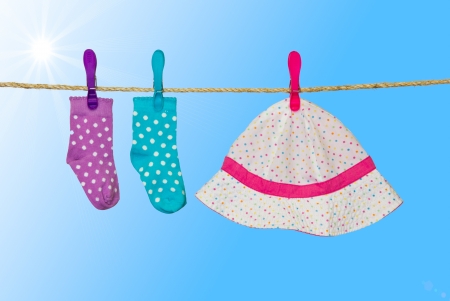 clothesline with baby socks and hatの写真素材