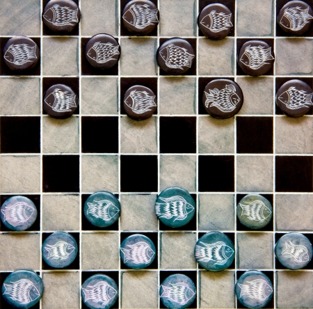 checkers game pieces made of ceramic on a game boardの写真素材