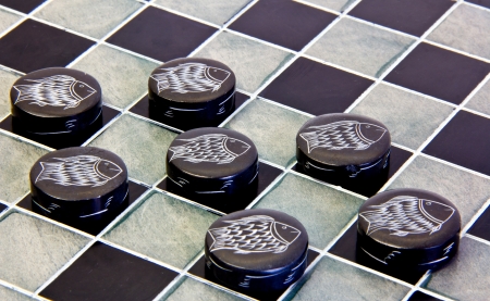 checkers game pieces made of ceramic on a game boardの写真素材