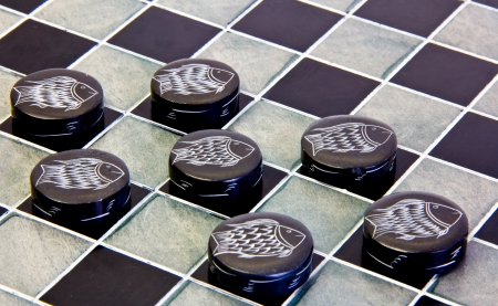 checkers game pieces made of ceramic on a game boardの素材 [FY31019122015]