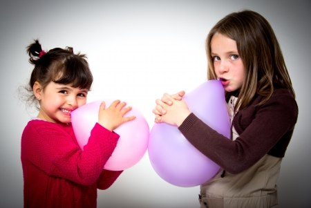 portrait of two little girls with balloonsの写真素材