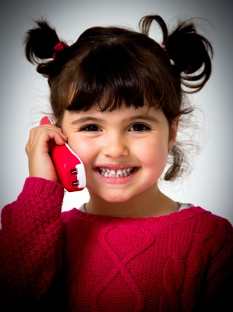 portrait of a little girl with phoneの写真素材