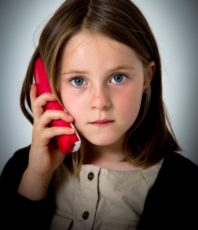portrait of a little girl with phoneの写真素材