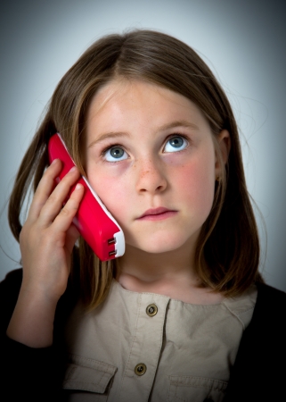 portrait of a little girl with phoneの写真素材