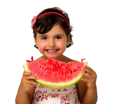little girl eating watermelon isolated on whiteの写真素材