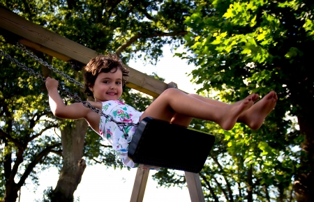 girl swinging in a parkの写真素材