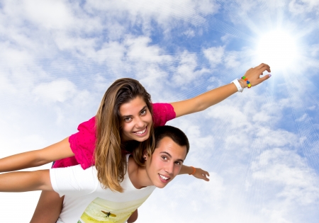 teen couple on a white clouds backgroundの写真素材