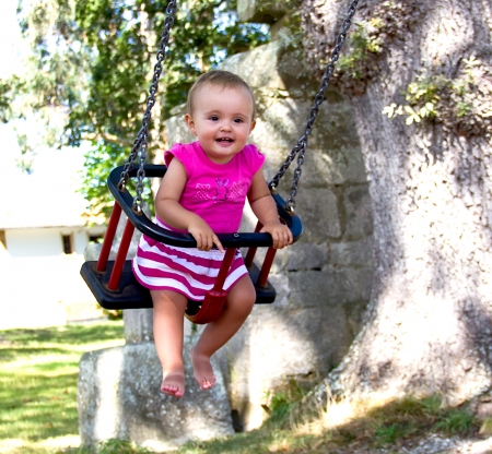 portrait of a baby on swingの写真素材