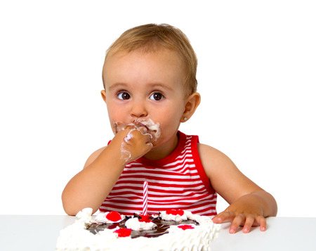 baby with birthday cake isolated on whiteの写真素材
