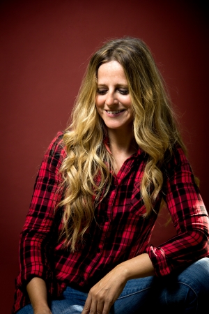 portrait of a middle aged woman on a red backgroundの写真素材