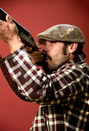 portrait of a hunter on a red backgroundの写真素材