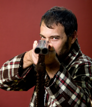 portrait of a hunter on a red backgroundの写真素材