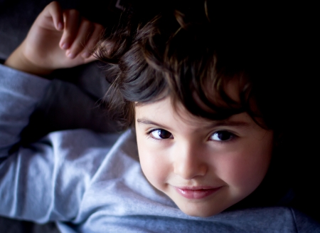 portrait of a little girl resting on her bedの写真素材