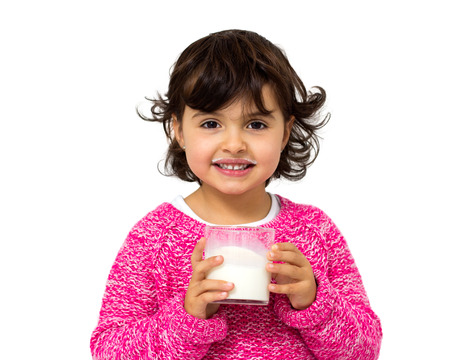 little girl with glass of milk isolated on whiteの写真素材