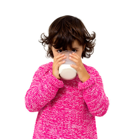 little girl with glass of milk isolated on whiteの写真素材