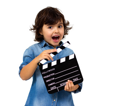 little girl with a clapperboard isolated on white