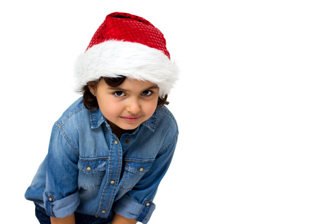 little girl with santaÂ´s hat isolated on whiteの写真素材