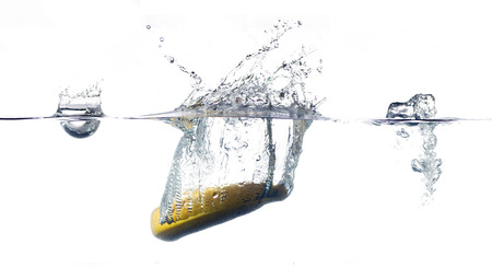banana falling and splashing into clear water.の写真素材