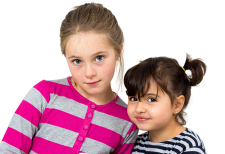 two happy little girls isolated on whiteの写真素材