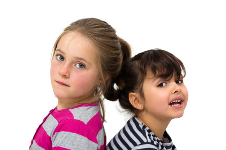two happy little girls isolated on whiteの写真素材