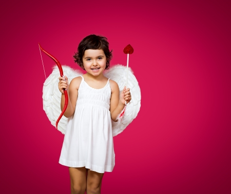 cupid little girl with a bow, arrow and wingsの写真素材