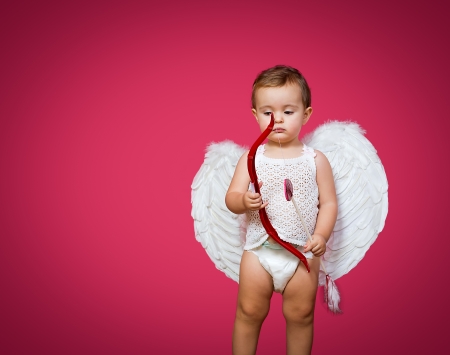 baby cupid with a bow, arrow and wingsの写真素材