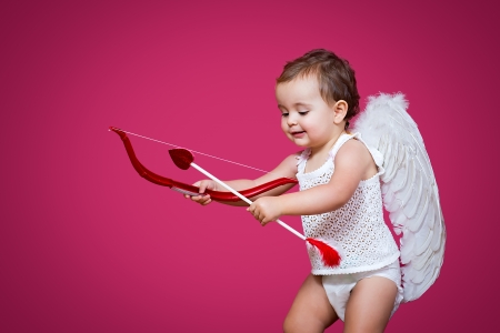 baby cupid with a bow, arrow and wingsの写真素材