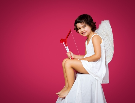 cupid little girl with a bow, arrow and wingsの写真素材