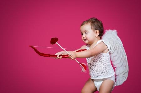 baby cupid with a bow, arrow and wingsの写真素材