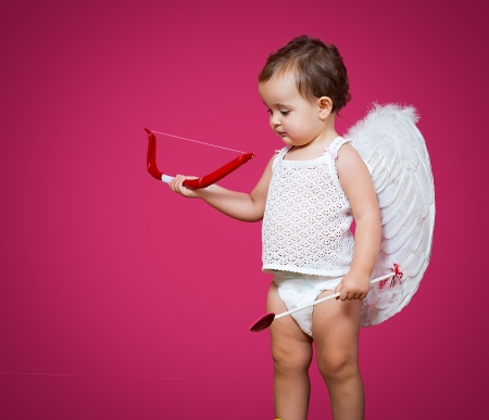 baby cupid with a bow, arrow and wingsの写真素材