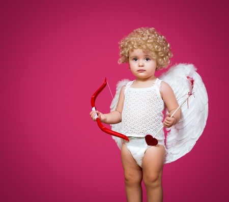 baby cupid with a bow, arrow and wingsの写真素材
