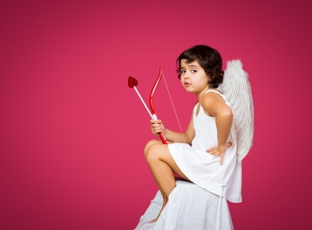 cupid little girl with a bow, arrow and wingsの写真素材