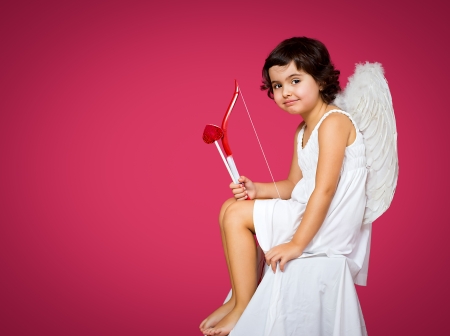 cupid little girl with a bow, arrow and wingsの写真素材