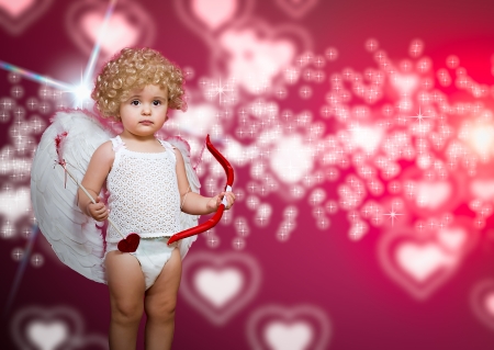 baby cupid with a bow, arrow and wingsの写真素材
