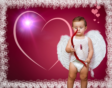baby cupid with a bow, arrow and wingsの写真素材