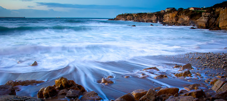 View of a rocky coast in the sunsetの写真素材