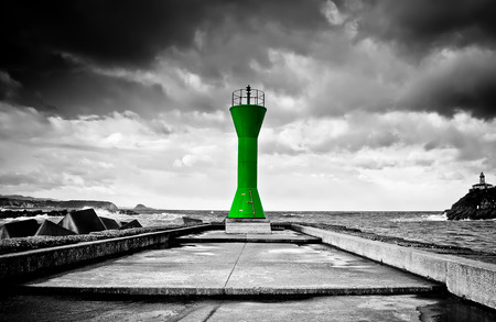 View of a green breakwater in rough seasの写真素材