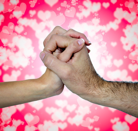 clasped hands with romantic backgroundの写真素材
