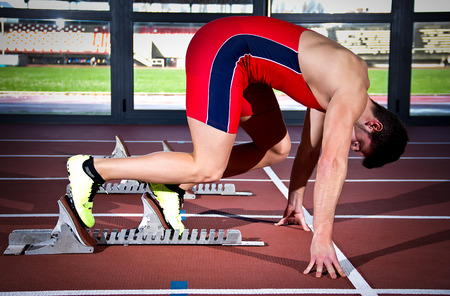 Man sprinter leaps from starting block.の写真素材