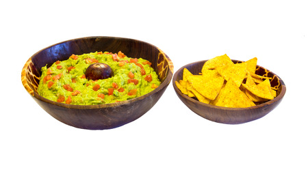 bowl of guacamole with nachos isolated on whiteの写真素材