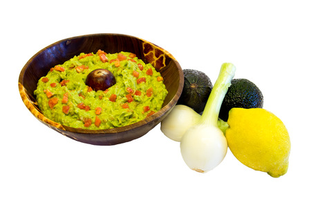 bowl of guacamole and some vegetables isolated on whiteの写真素材