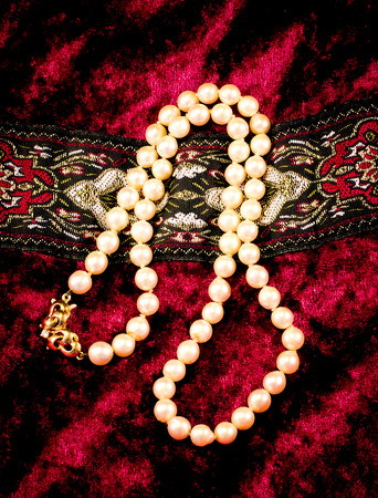 pearl necklace on a red fabricの写真素材