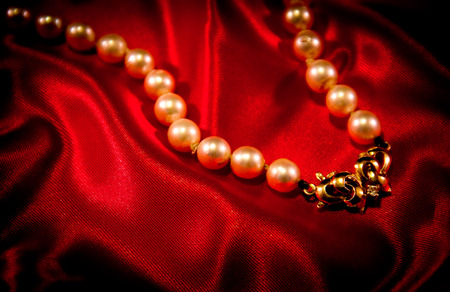 pearl necklace on a red fabricの写真素材