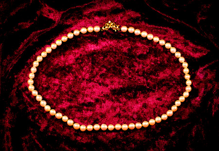 pearl necklace on a red fabricの写真素材