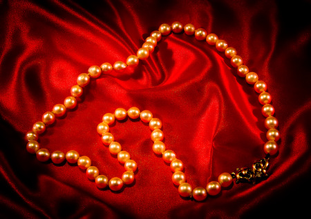 pearl necklace on a red fabricの写真素材