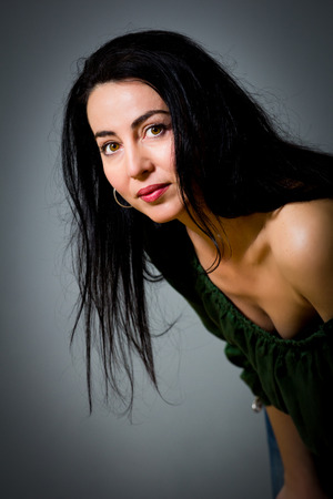 Portrait of a beautiful woman with black hair and green eyesの写真素材
